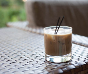 A Cold Bew XO cocktail sitting on a rattan table