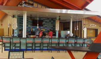 Two bartenders waiting to serve guests at the Oasis Pool Bar.